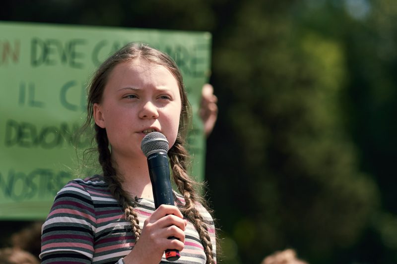 ROME, ITALY - April 19, 2019: Swedish climate activist Greta Thunberg attending Fridays For Future (School Strike for Climate) protest in front of a huge crowd near the Colosseum