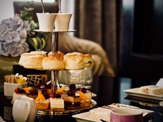 scones on tall tray next to tea set on fine hotel table